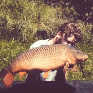 Matt Peplow proudly holding a massive Common Carp catch